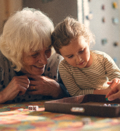 Woman playing board game with grand-daughter